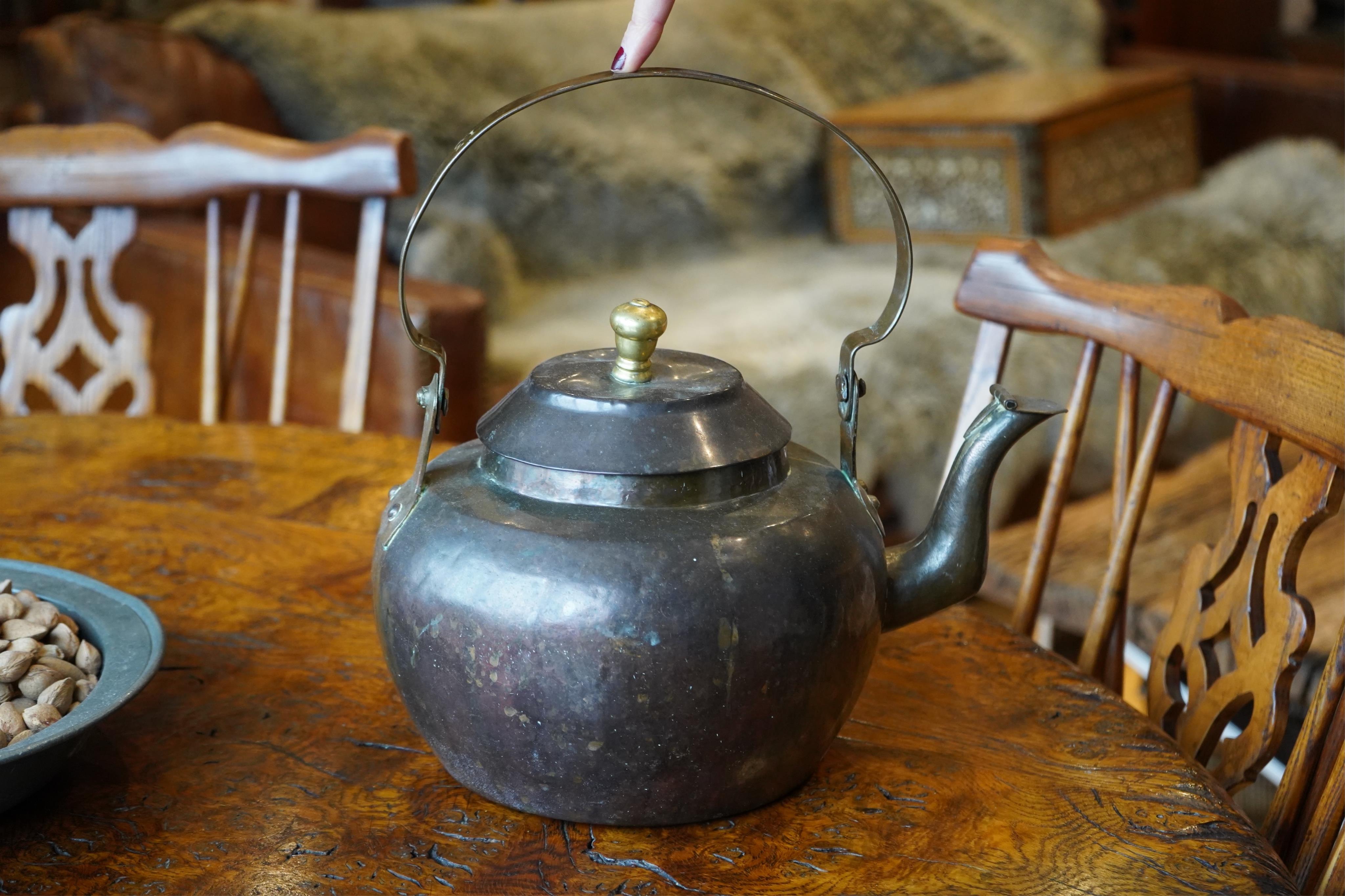 A Dutch copper kettle with brass knop, 34cm wide. Condition - fair